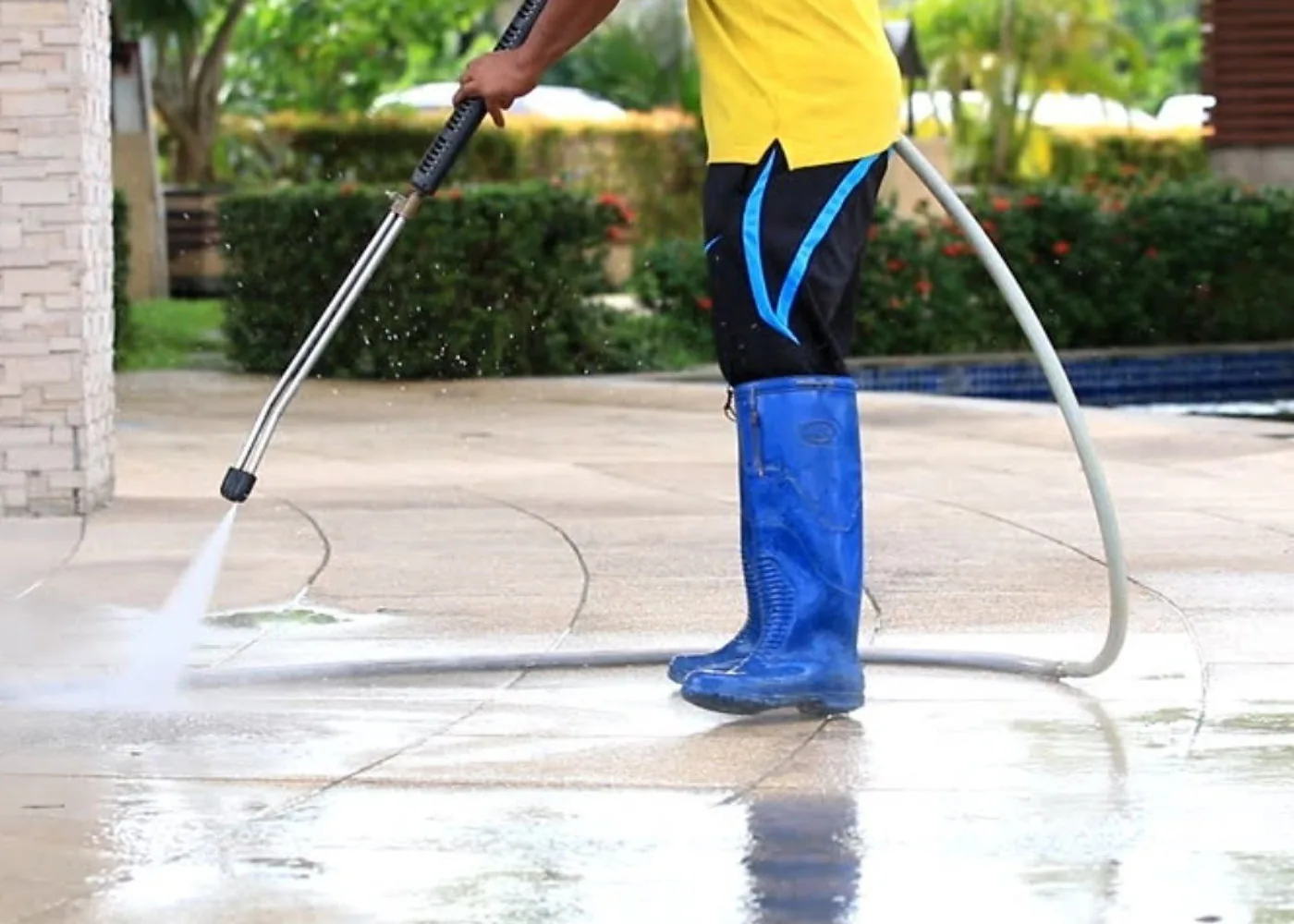 Professional pressure washing on a paved driveway