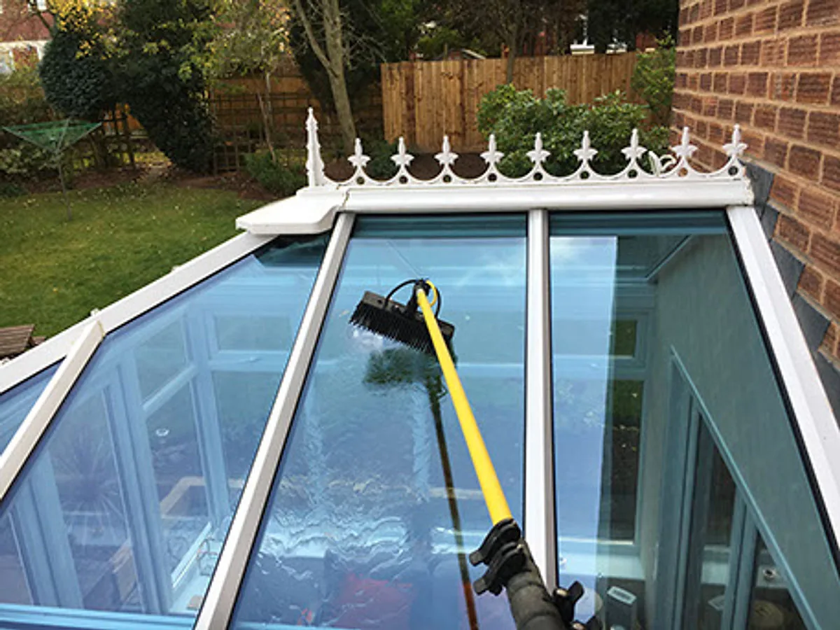 A conservatory roof being professionally cleaned